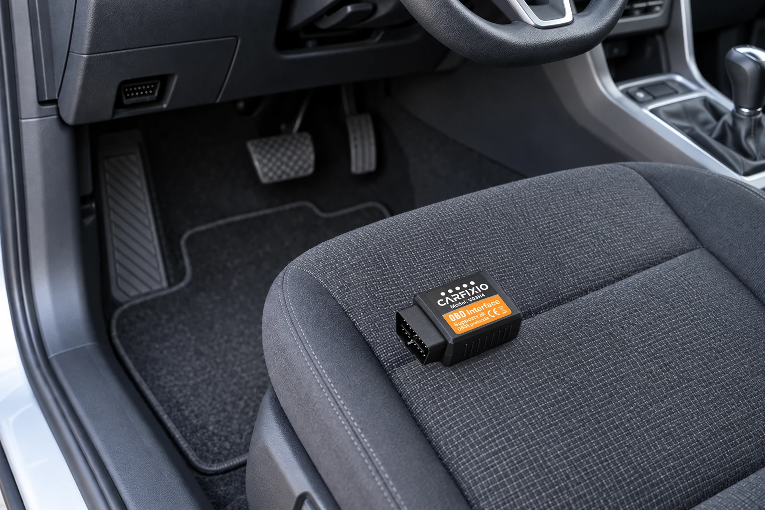 OBD2 scanner plugged in beneath a car dashboard